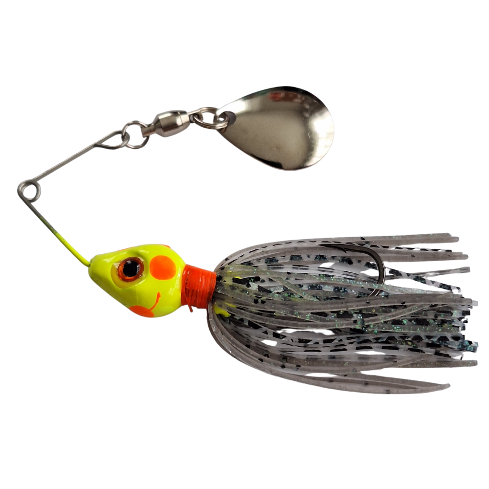 Fishing lure with a metal spoon and colorful head on a white background